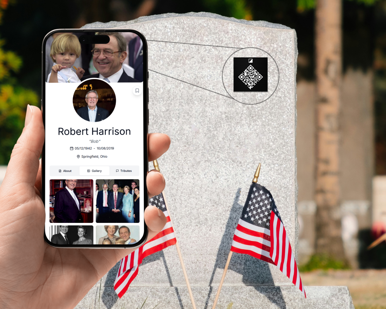 Hand holding a phone with a social media profile displayed, in front of a gravestone with American flags.