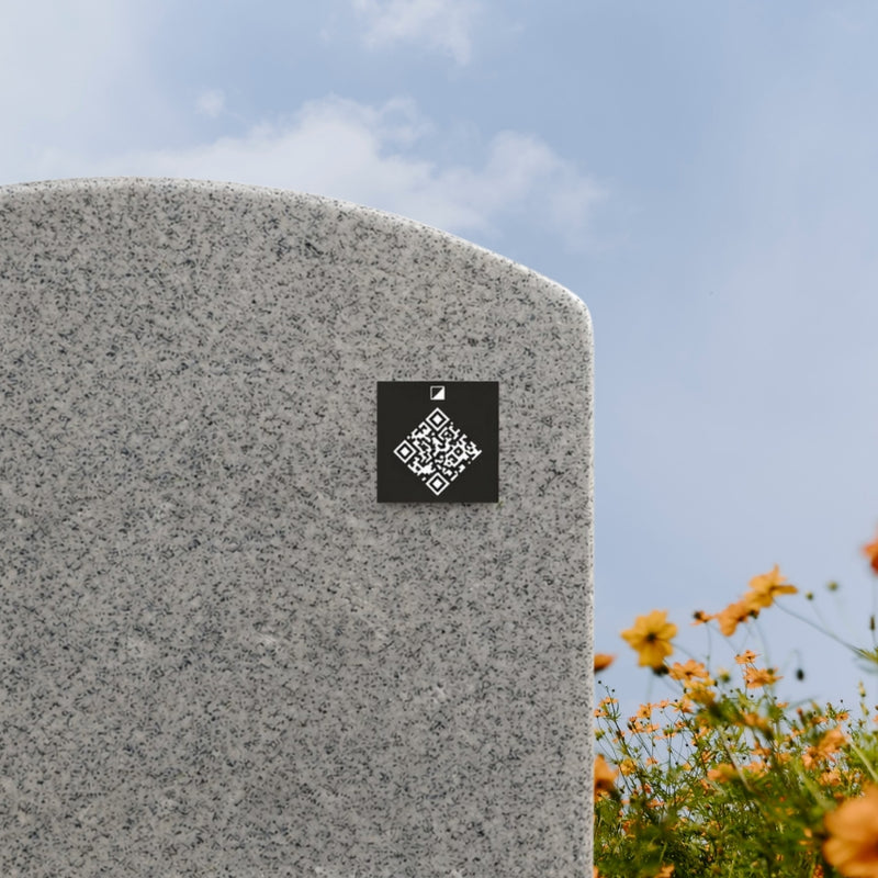 Hands pressing the QR memorial plate onto a granite headstone